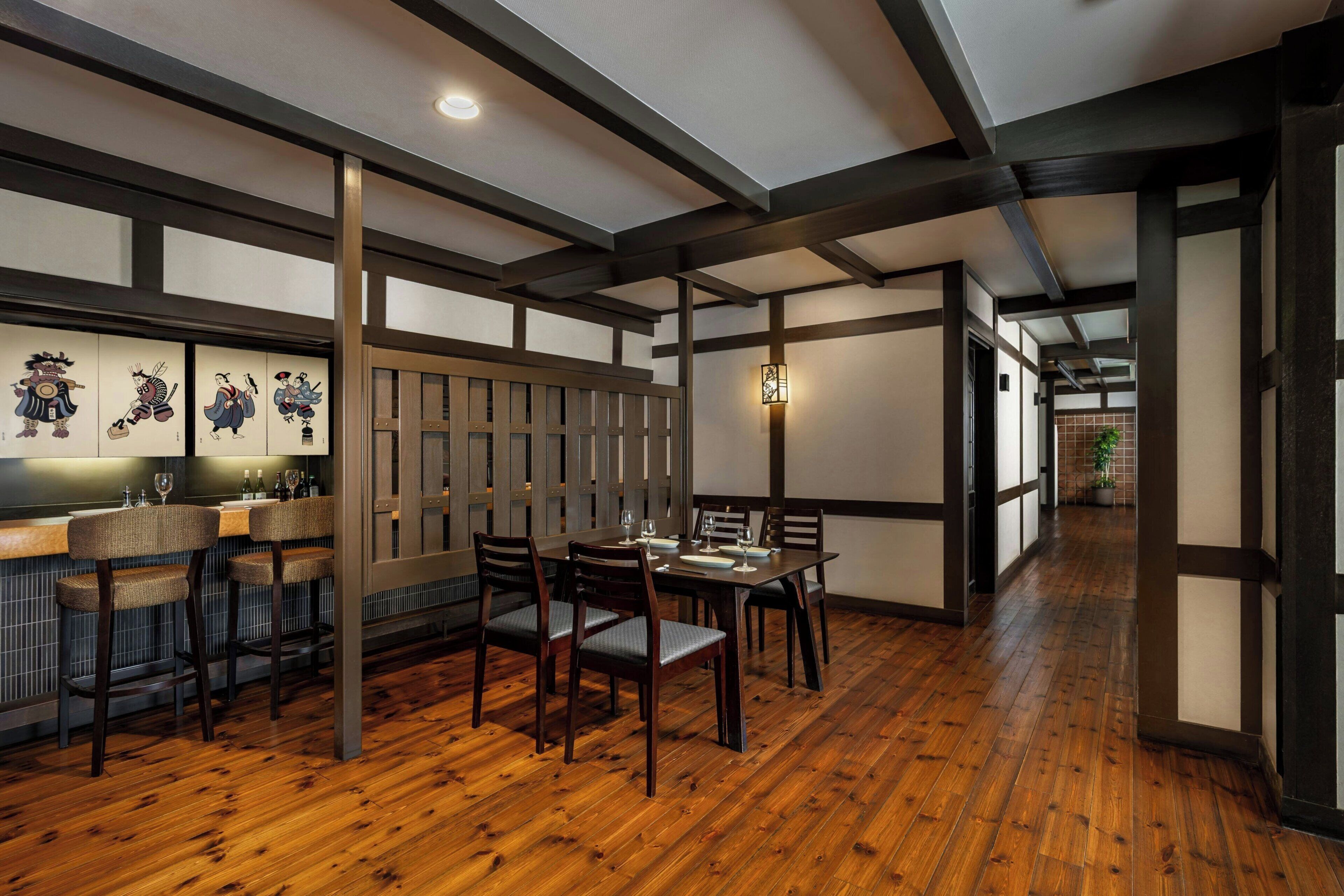 A traditional Japanese-style interior with tatami flooring, wooden furniture, and shoji screens.