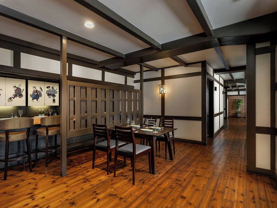 A traditional Japanese-style interior with tatami flooring, wooden furniture, and shoji screens.