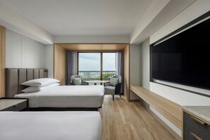A hotel room with two beds, a TV, a balcony with a view, and a small table. - Hamamatsu Marriott Hotel (Hamamatsu)