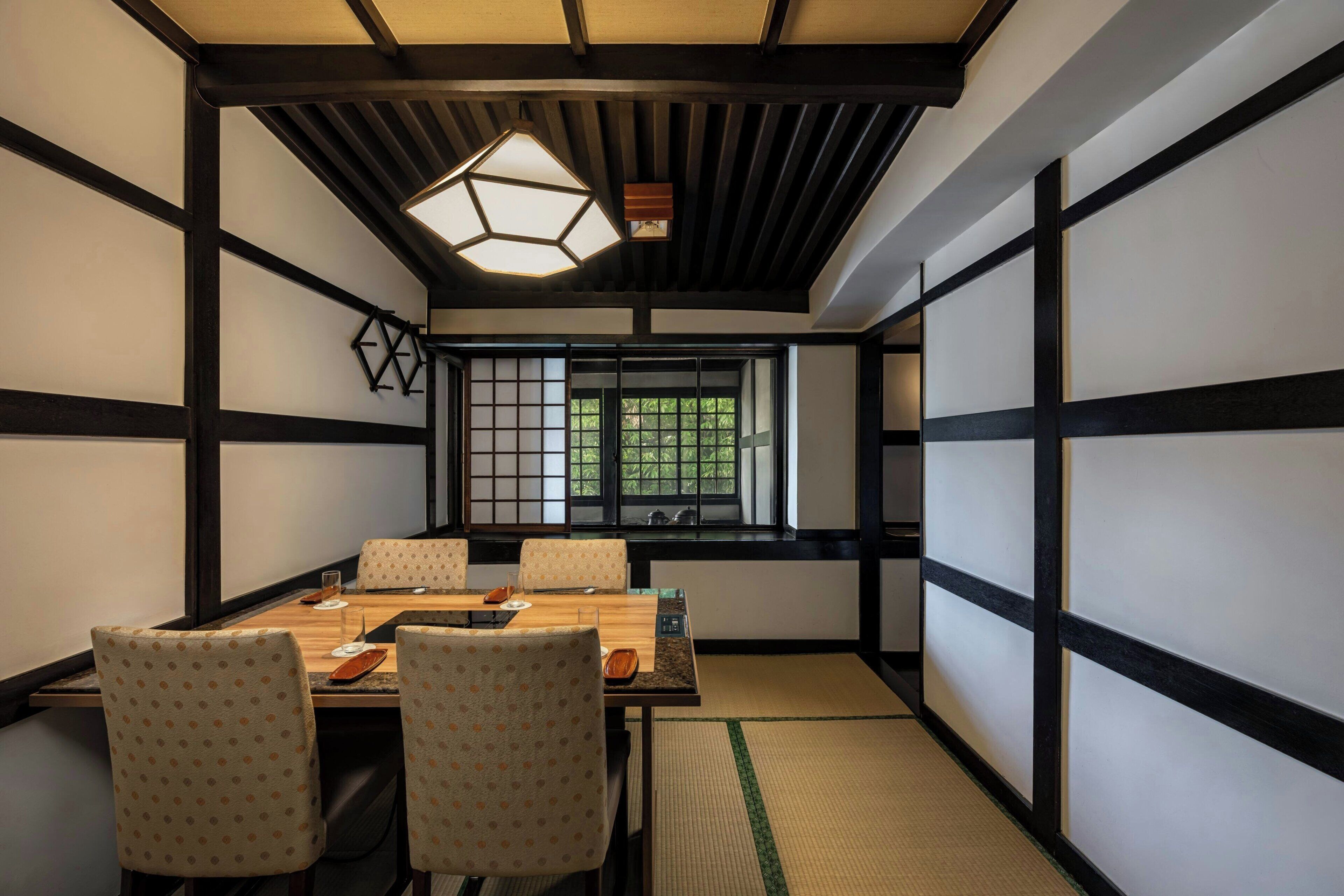 A traditional Japanese room with tatami flooring, a low table, and shoji screens.
