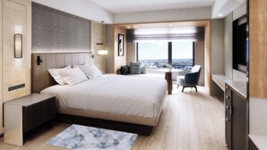 Una habitación de hotel moderna con una cama grande, un escritorio y vistas a la ciudad.