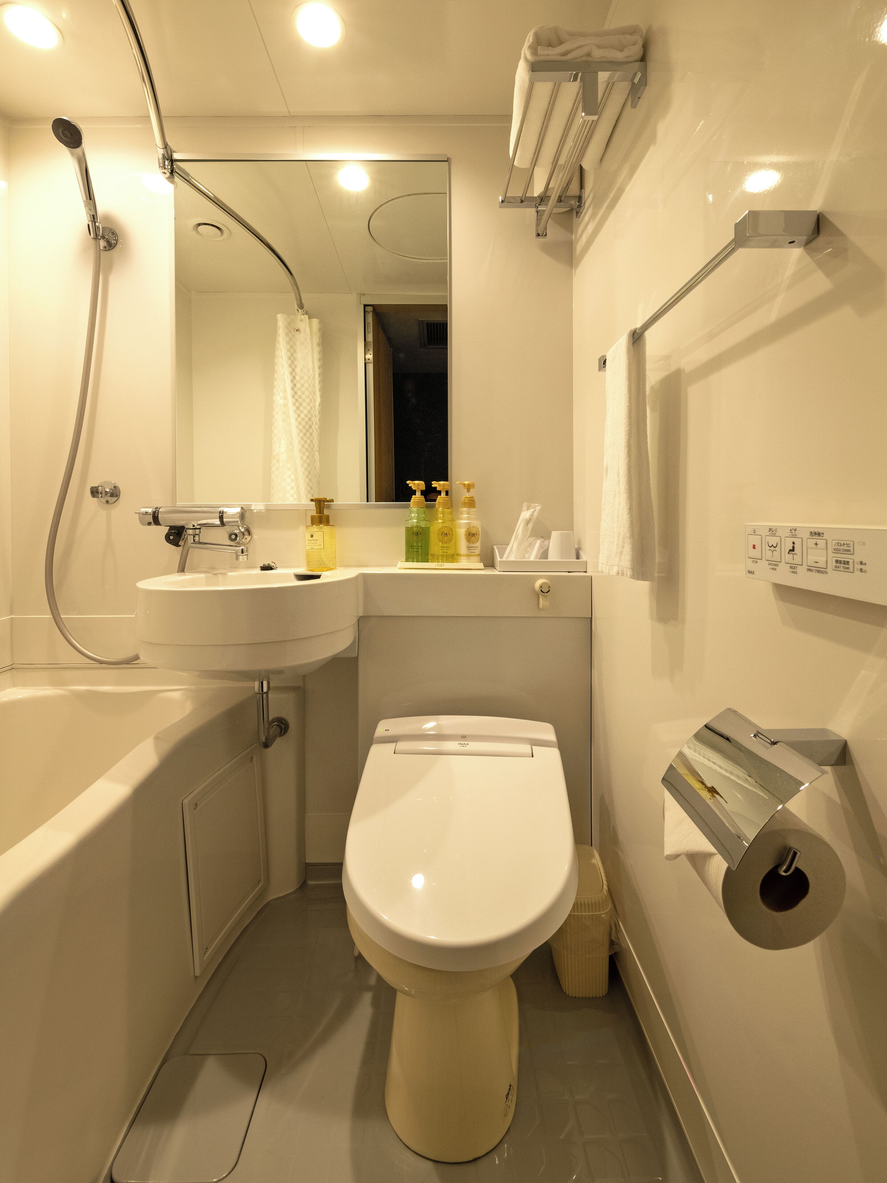 A modern bathroom with a bathtub, toilet, and sink.