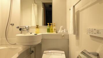 A modern bathroom with a bathtub, toilet, and sink.