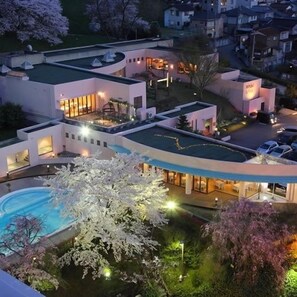 A modern hotel with multiple buildings, a swimming pool, and well-lit outdoor areas. - Kanazawa Kokusai Hotel (Kanazawa)