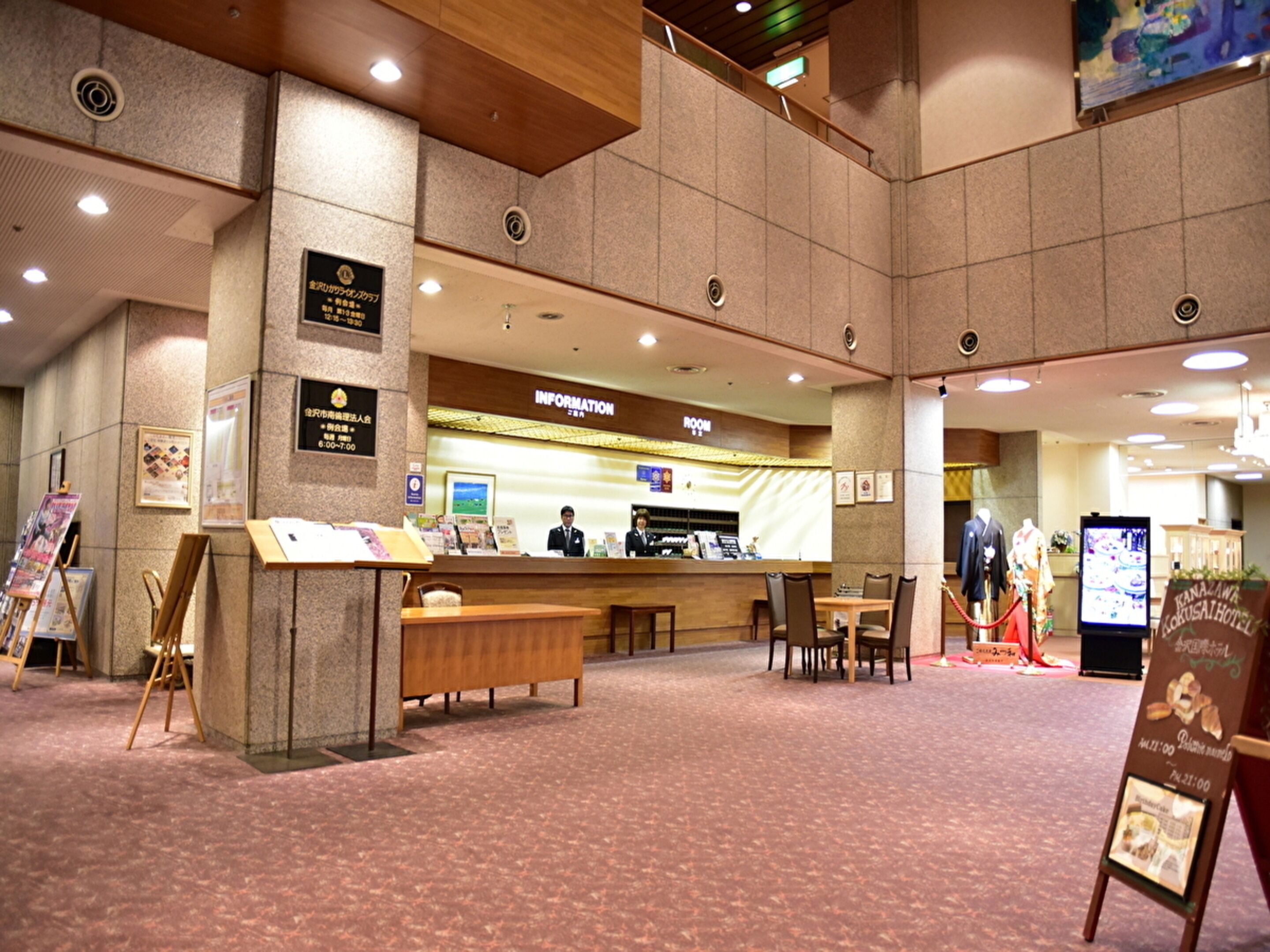 A reception area with a counter, seating, and informational displays.