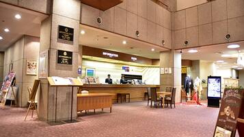 A reception area with a counter, seating, and informational displays.