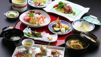 A variety of dishes and bowls on a table, suggesting a meal setting.