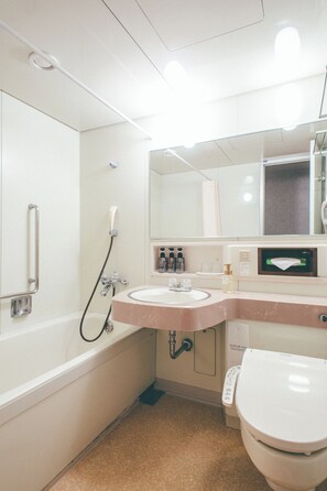 A modern bathroom with a bathtub, a sink, a toilet, and a shower. - Kanazawa Kokusai Hotel (Kanazawa)
