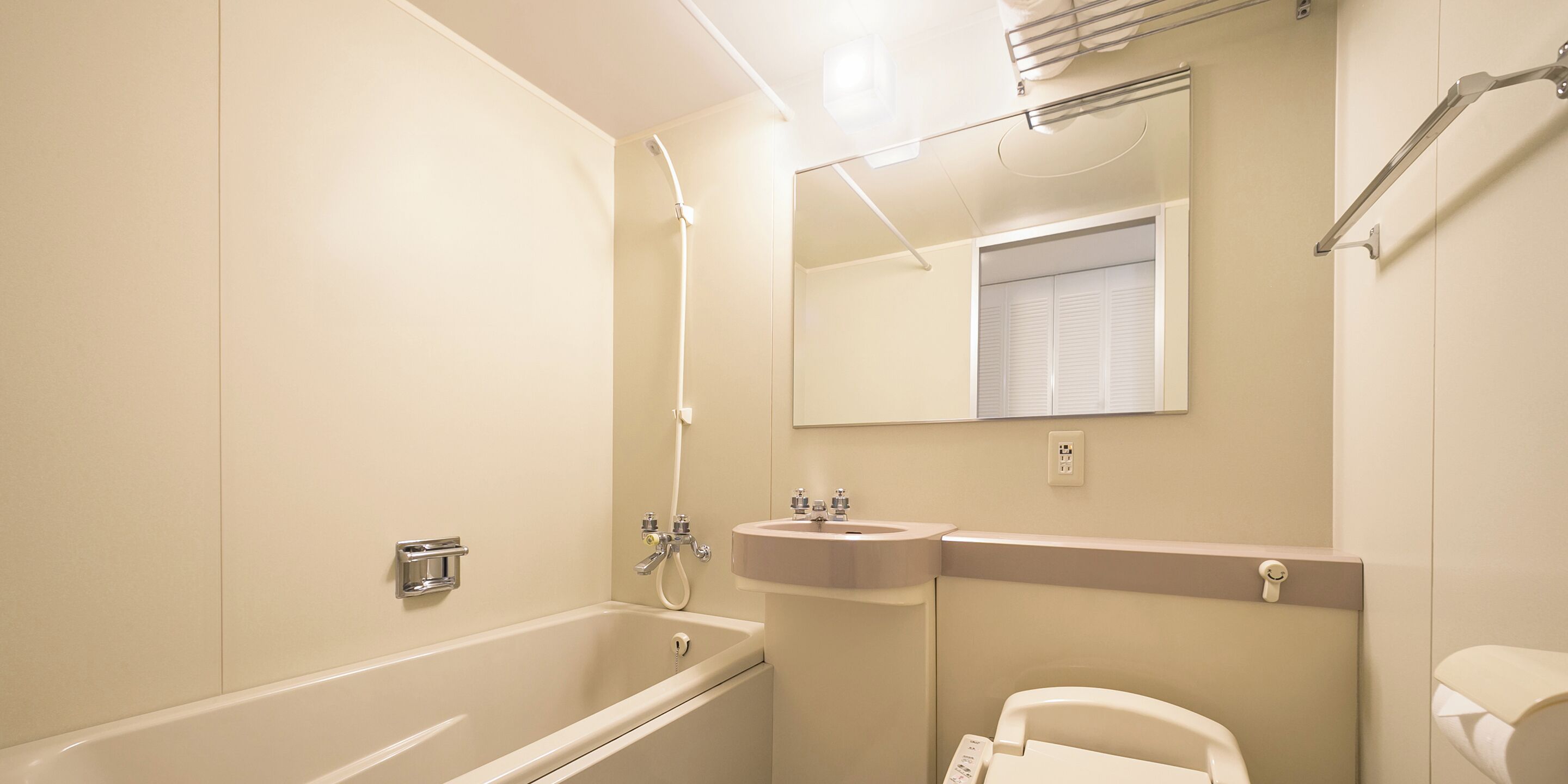 A bathroom with a bathtub, a sink, and a toilet.