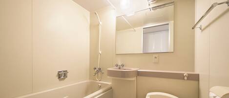 A bathroom with a bathtub, a sink, and a toilet.