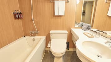 A bathroom with a bathtub, toilet, sink, and a mirror.