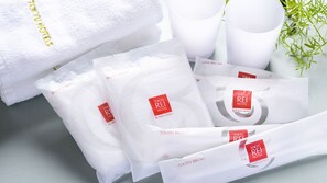 A set of toiletries including body towels, hairbrush, and tooth brush, all branded with Tokyo Rei Hotel. - Takamatsu Tokyu REI Hotel (Takamatsu)