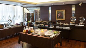 A buffet setup with various food items and beverages, a large mirror, and a framed picture on the wall. - Rihga Hotel Zest Takamatsu (Takamatsu)