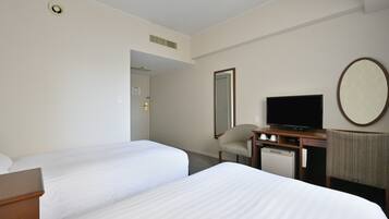 A hotel room with two beds, a desk with a television, a chair, and a large mirror on the wall.