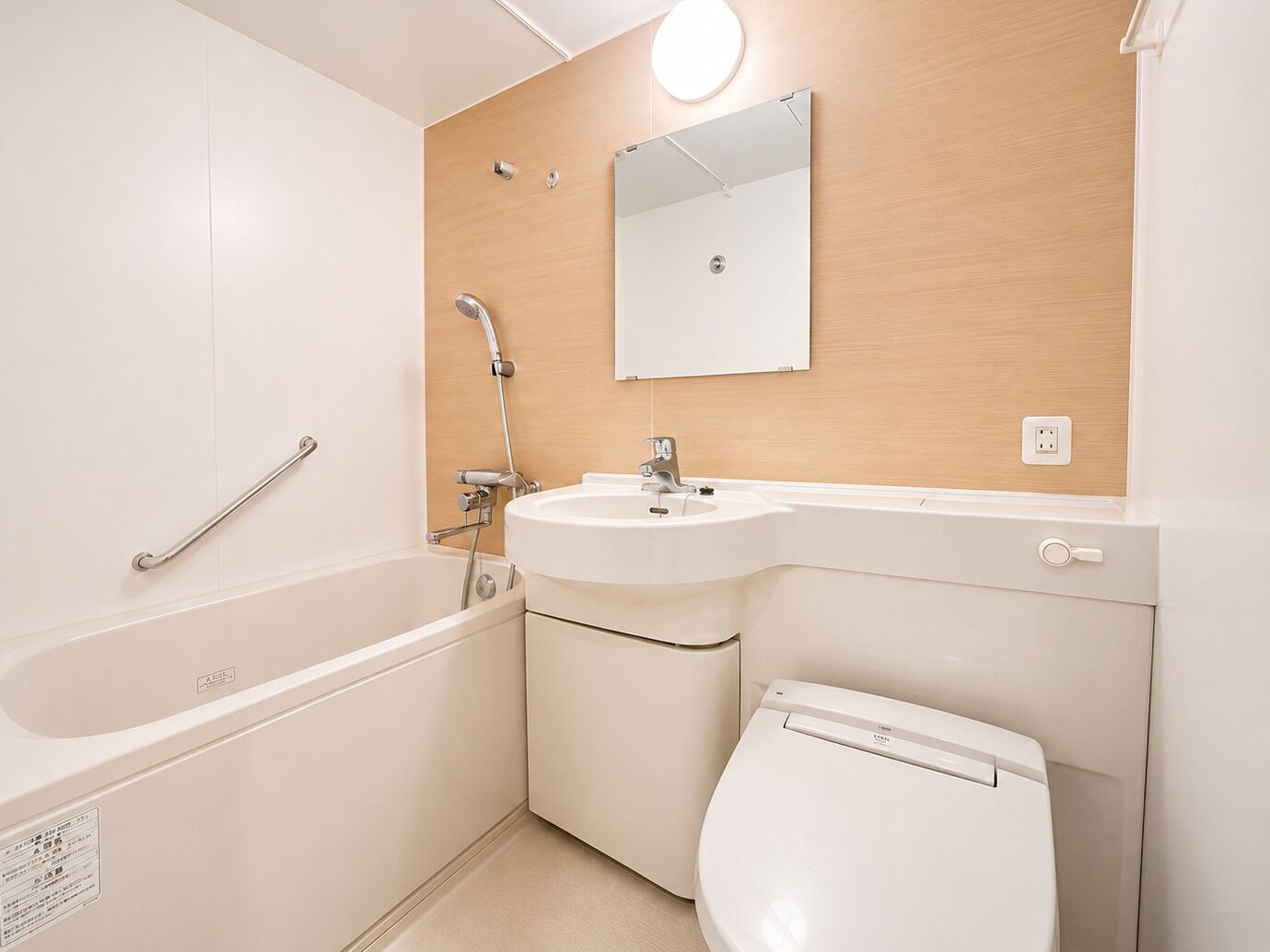 A modern bathroom with a bathtub, sink, and toilet.