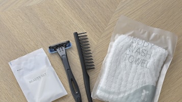 Un paquete etiquetado como "BODY WASH TOWEL" y un "BEAUTY SET" sobre una superficie de madera.