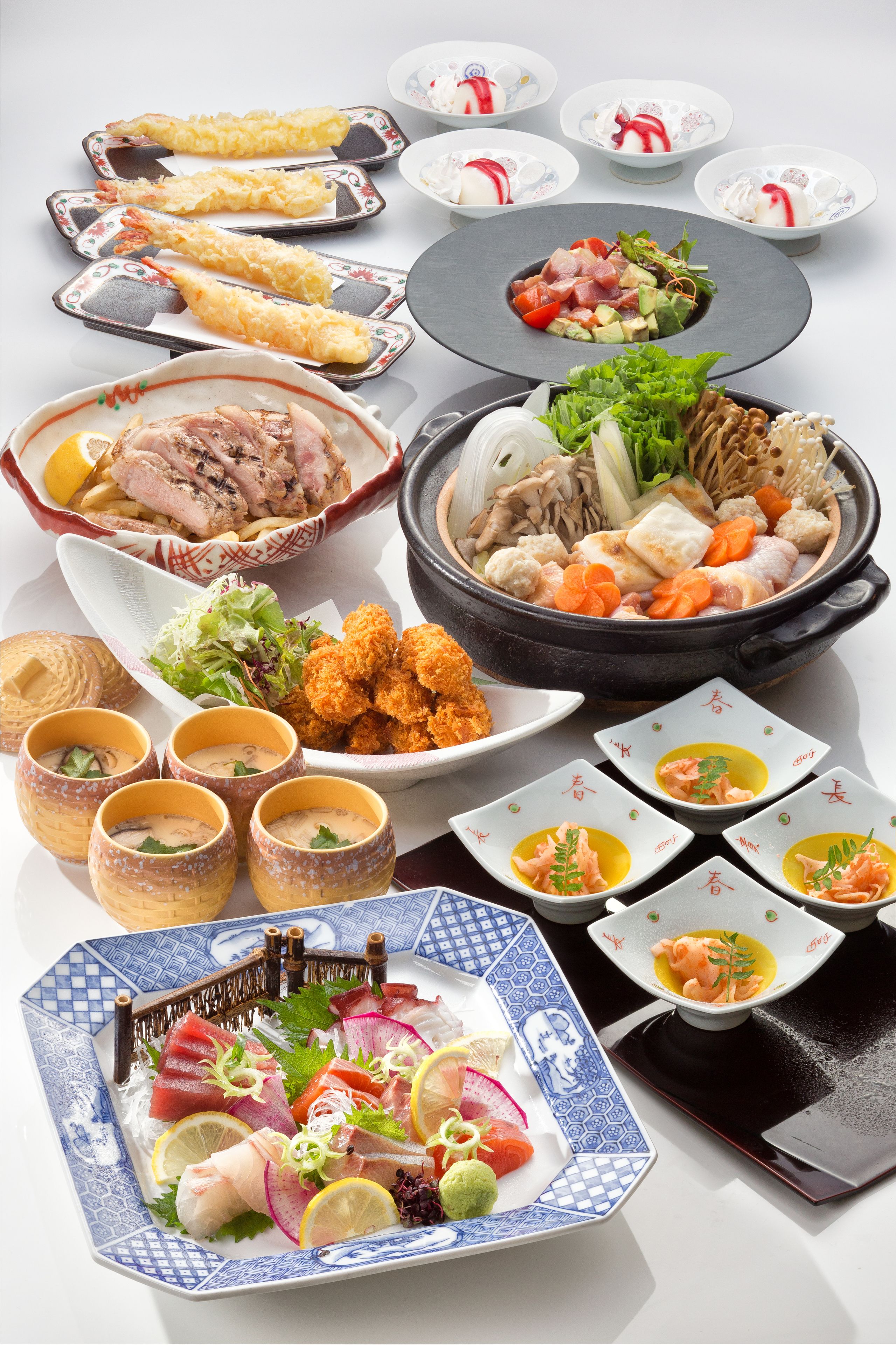 A variety of dishes including sushi, sashimi, and tempura.