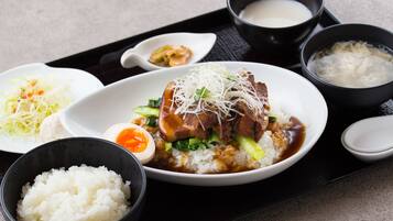 A meal with rice, meat, and vegetables, accompanied by small bowls of soup and condiments.