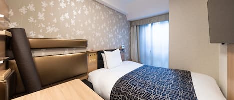 A hotel room with a bed, a desk, a chair, a control panel, and a window with curtains.