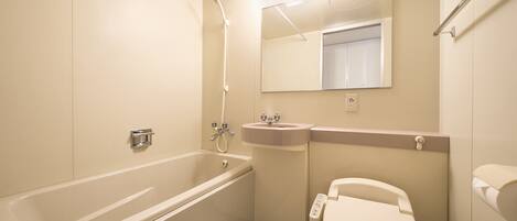 A modern bathroom with a bathtub, sink, and toilet.