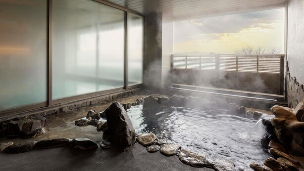 A hot spring area with a view of the sky through a large window.