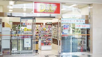 A New Daily Store with a variety of products on shelves and a checkout area.