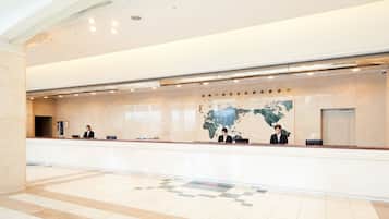 A reception area with a large world map, a reception desk, and a check-in counter.