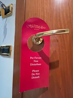 Hotel Valle Rossia's guest room door features a discreet 'Do Not Disturb' sign.