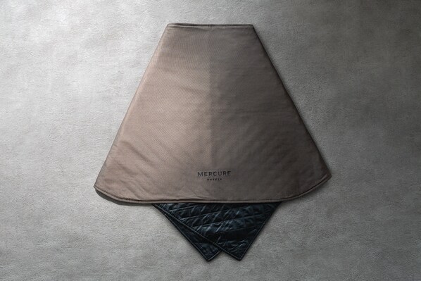 A folded bedspread with the text "MERCURE HOTELS" on it. - Mercure Kyoto Miyazu Resort & Spa (Miyazu)