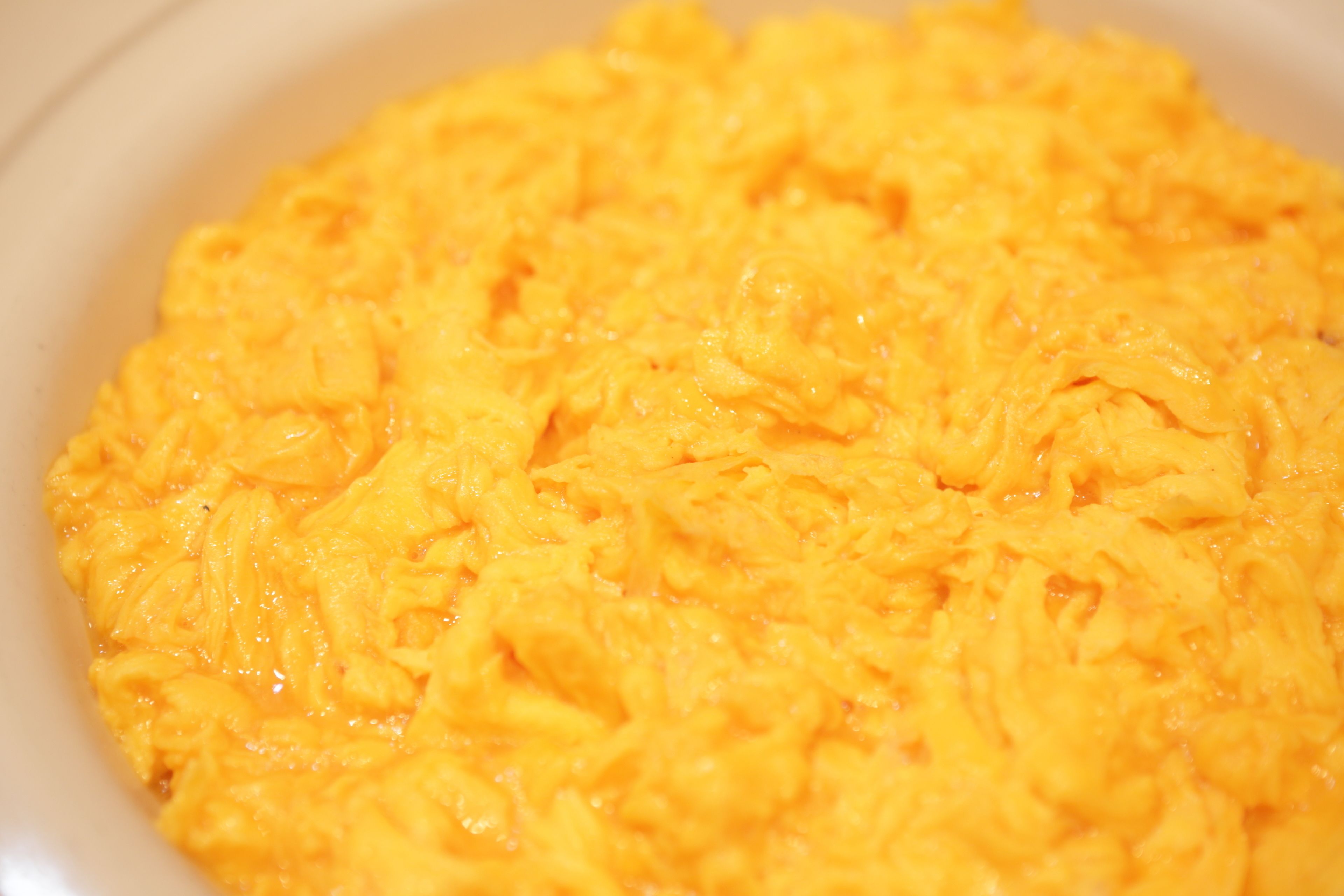 A bowl of scrambled eggs.