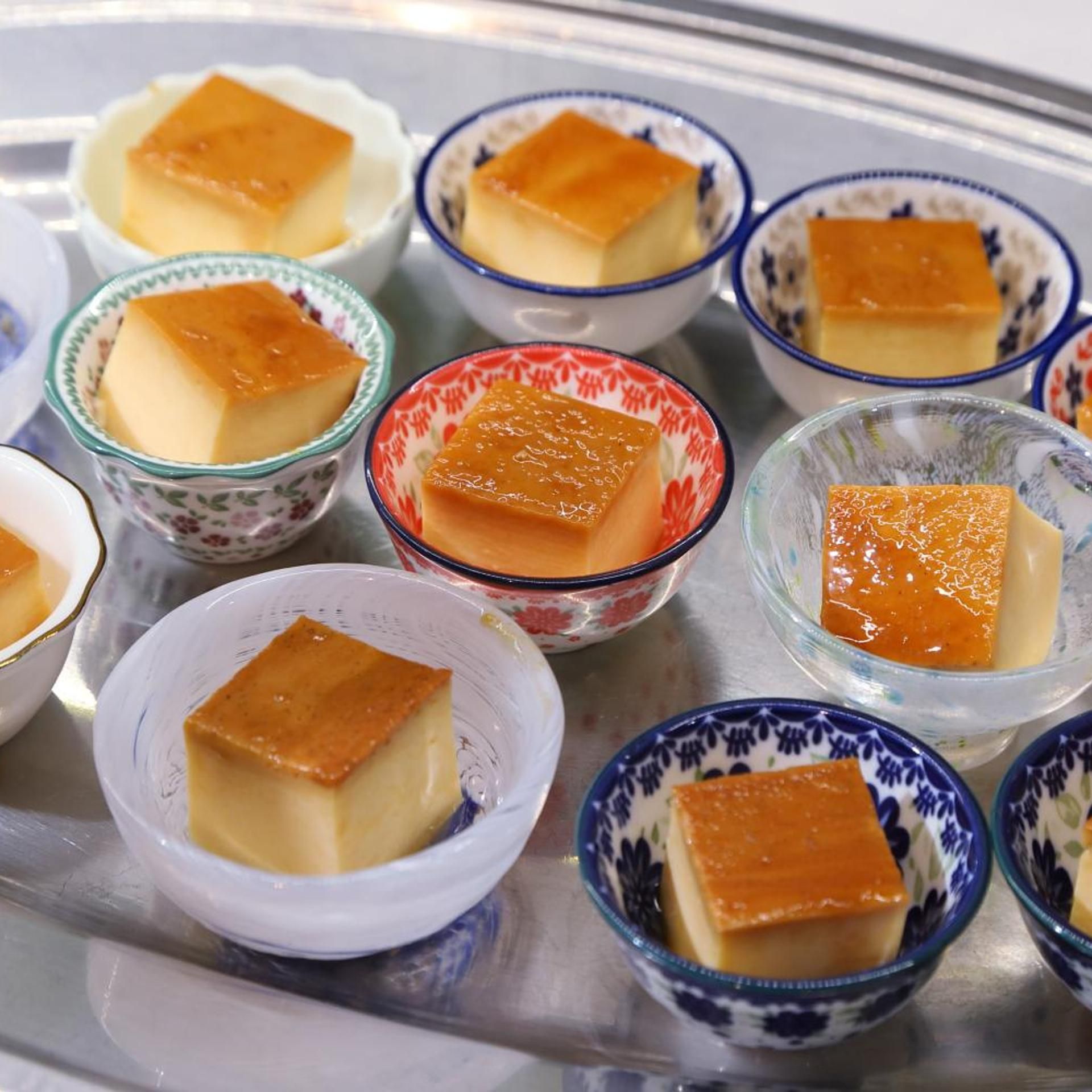 A selection of custard desserts in various bowls.