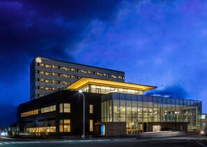 A modern hotel with a glass facade, a flat roof, and a prominent entrance. - Tsukino Hotel (Sakata)