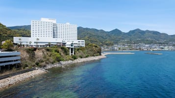 Overlooking the clear blue sea, this hotel offers stunning views from its multi-story structure with flat roof and balconies.