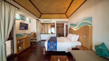 A hotel room with a bed, a desk, a chair, and a small table.