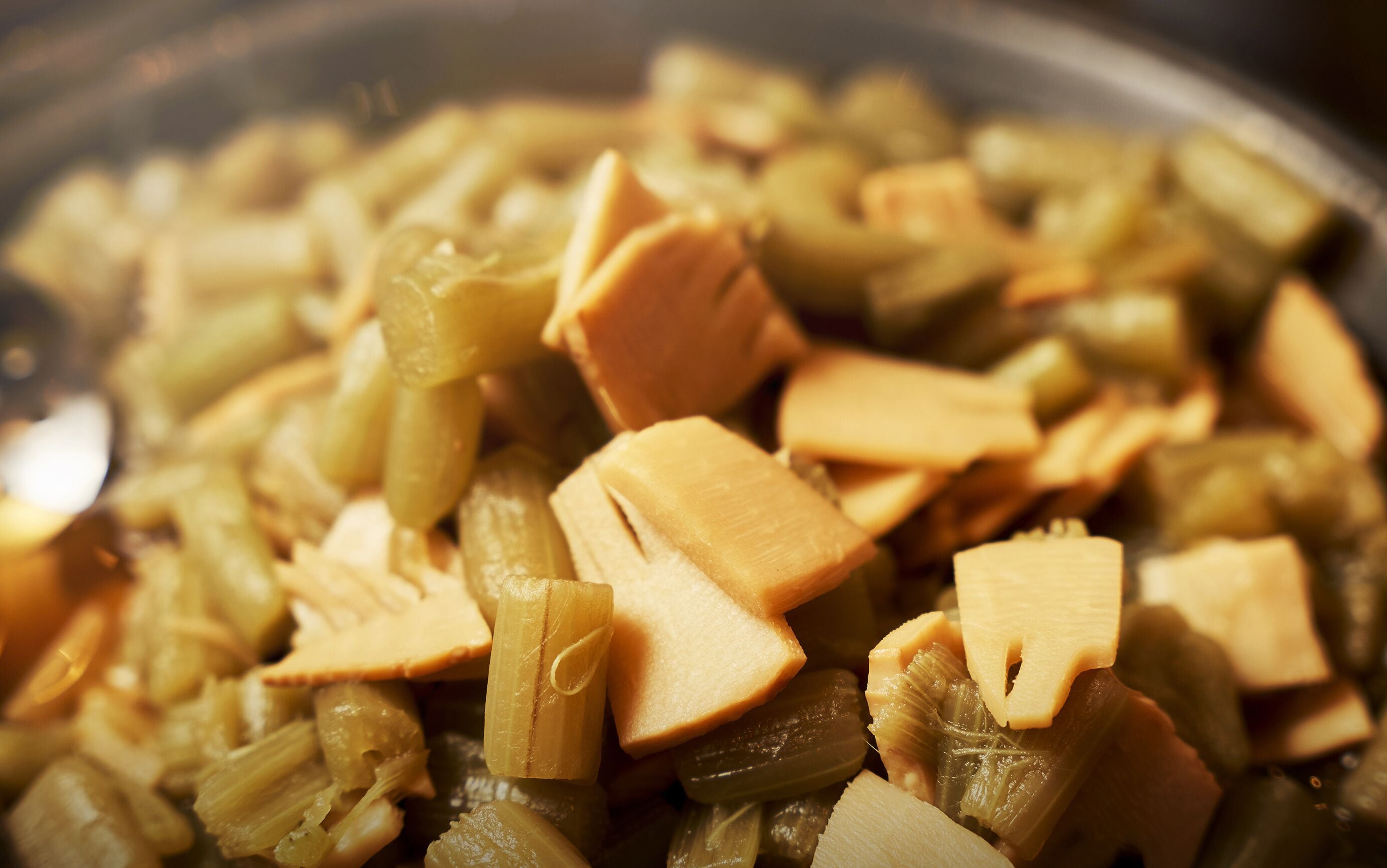 A close-up of a dish with sliced vegetables and tofu.
