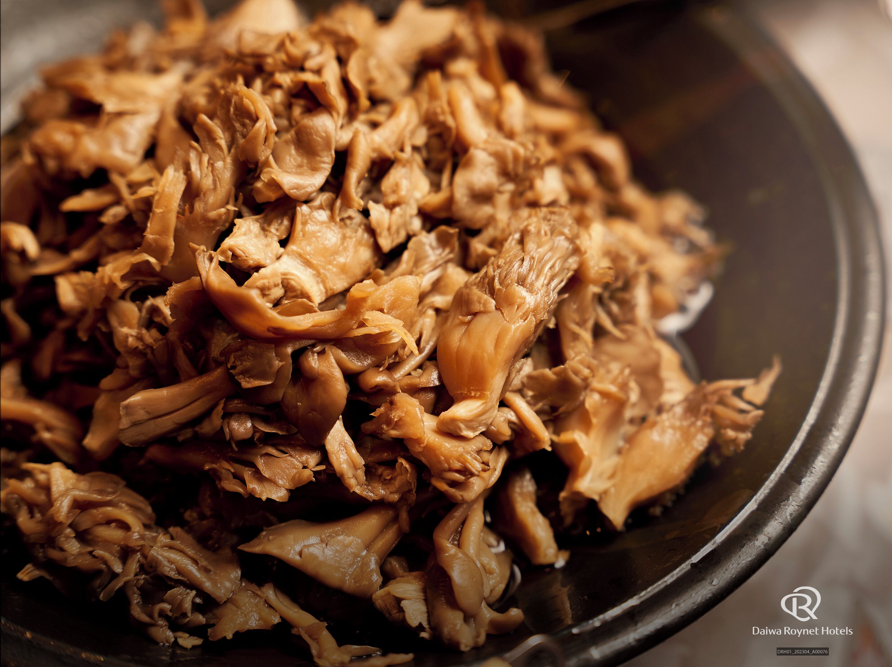 A close-up of shredded meat in a bowl.