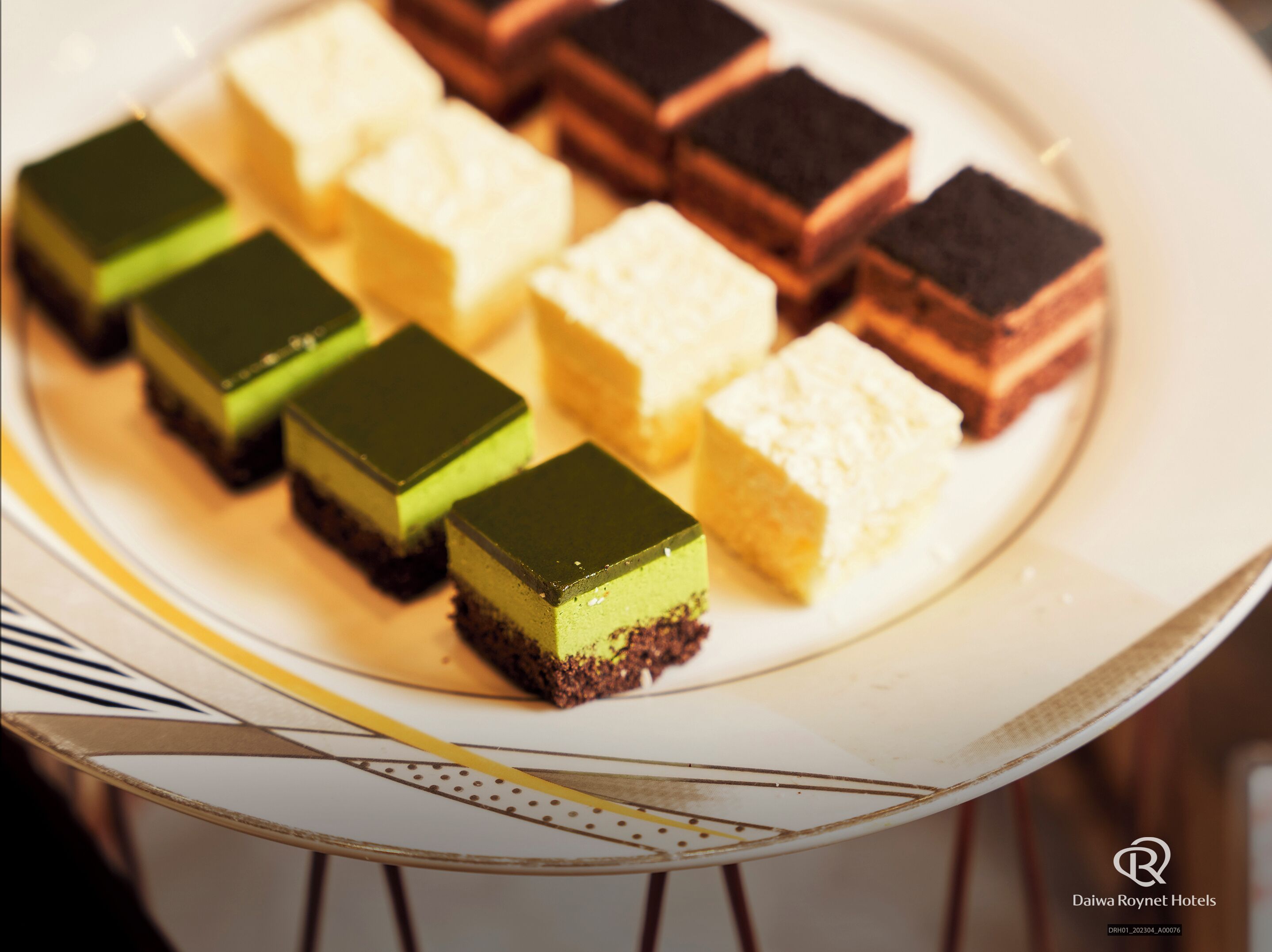 A plate of assorted square desserts.