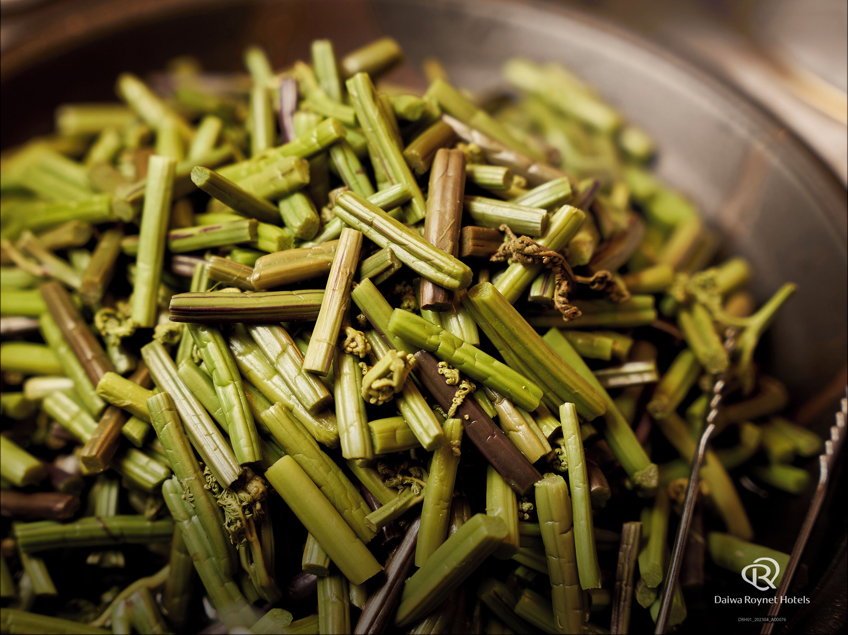 A close-up of cooked okra in a metal bowl.