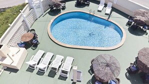 A rooftop pool area with lounge chairs, umbrellas, and a central pool. - Cala Bona & Mar Blava Hotels (Ciutadella de Menorca)