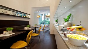 A modern dining area with a buffet, seating, and a view of the outdoors. - ImperialArt (Merano)