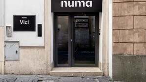 A building entrance with a black sign reading "numa Vici". - Numa Rome Vici (Rome)