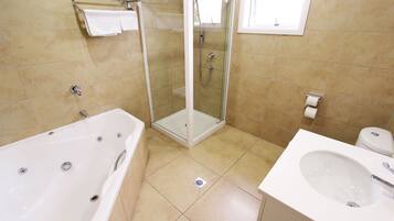 Deluxe Studio, Jetted Tub | Bathroom | Hair dryer, towels, soap, toilet paper