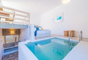 A modern bathroom with a large bathtub, a small sink, and a shower area. - Pylaia Boutique Hotel & Spa (Astypalaia)