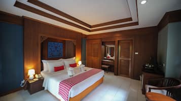 A hotel room with a large bed, bedside tables, a desk, and a chair.