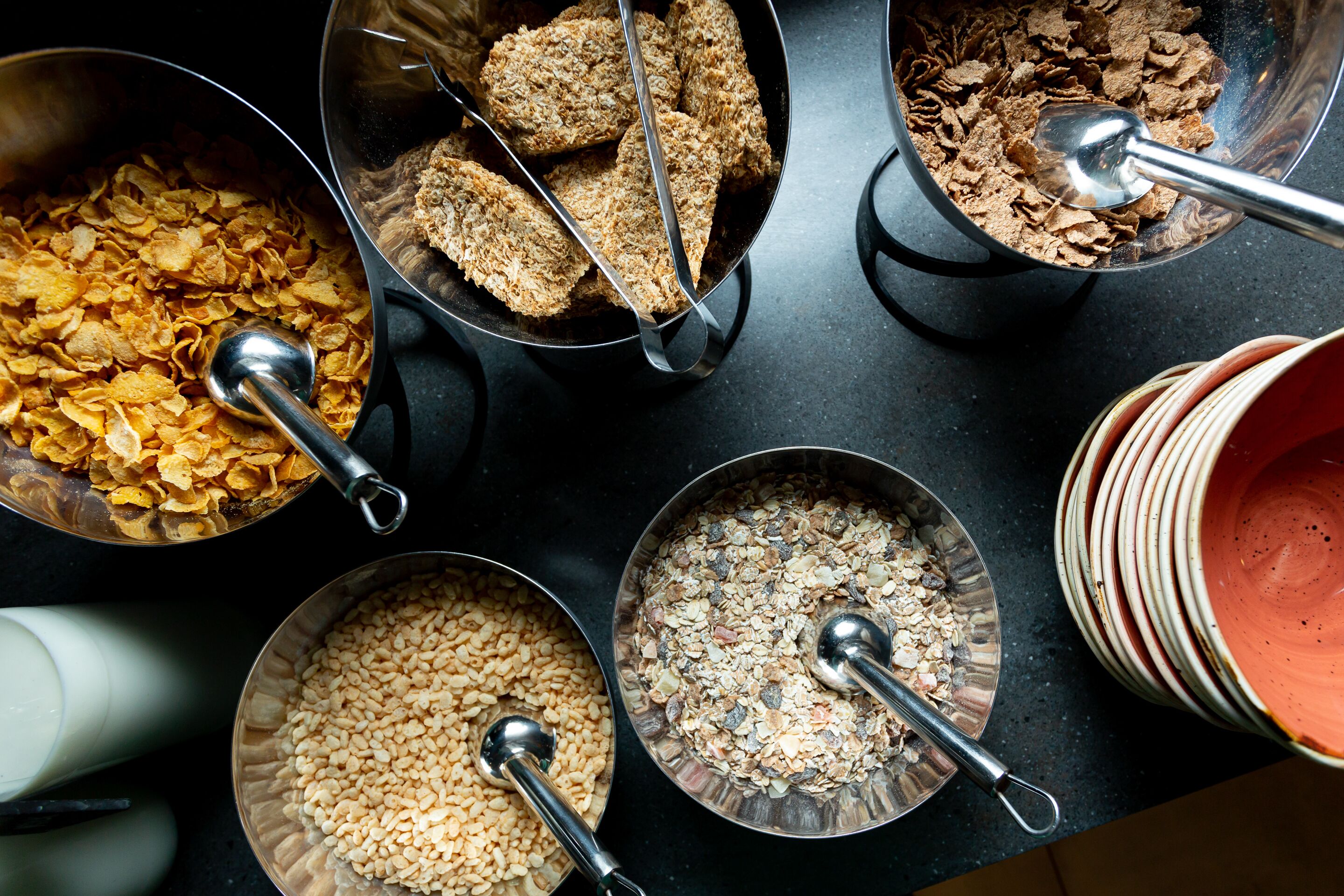 A top-down view of various food items in metal bowls on a table.