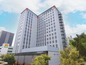 A modern hotel building with multiple floors and a prominent sign. - APA Hotel Keisei Narita Ekimae (Narita)