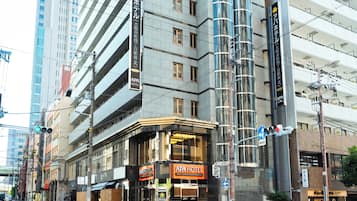 A hotel with multiple floors, large windows, and a prominent sign.