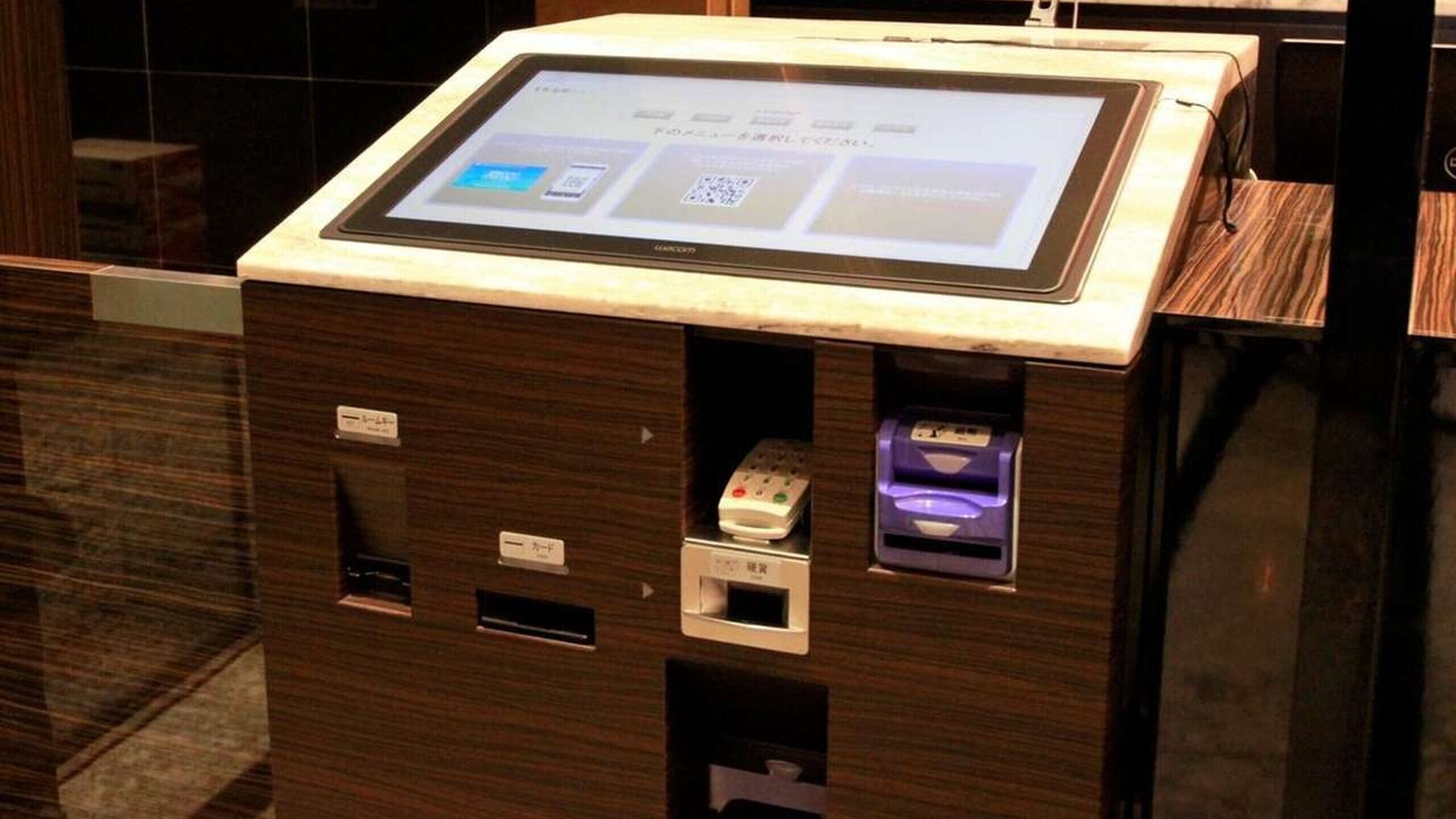 A self-service kiosk with a touchscreen interface, a card reader, and a cash dispenser.