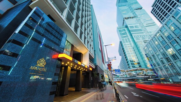 A modern hotel with a prominent entrance, large glass windows, and a well-lit facade. - APA Hotel Tennoji Ekimae (Osaka)