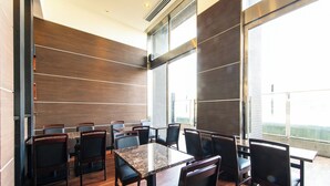 A conference room with a large table and chairs, wooden panel walls, and large windows with a view. - APA Hotel Tennoji Ekimae (Osaka)
